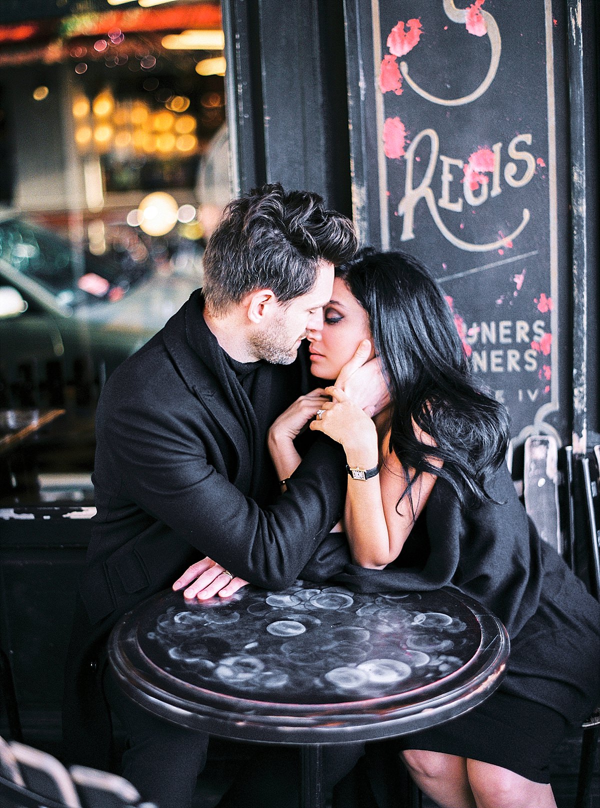 kissing couple in paris at a cafe
