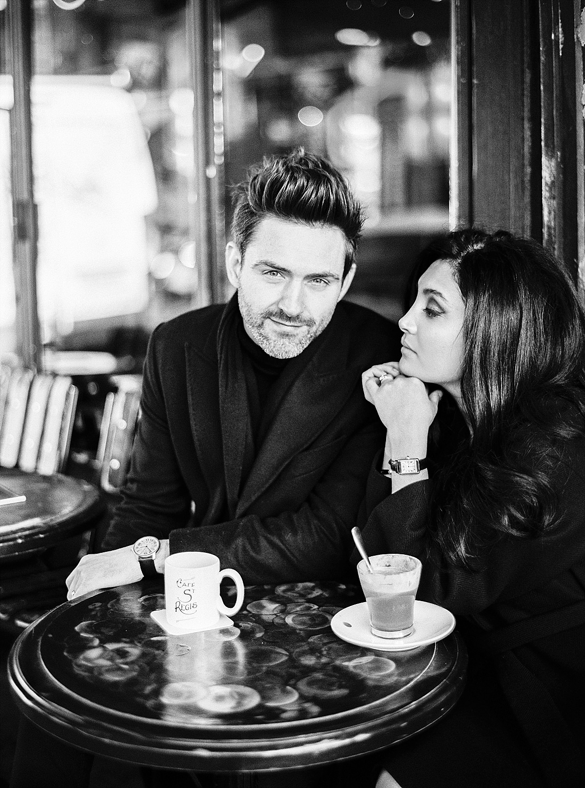 black and white film portrait of a couple sitting at a cafe
