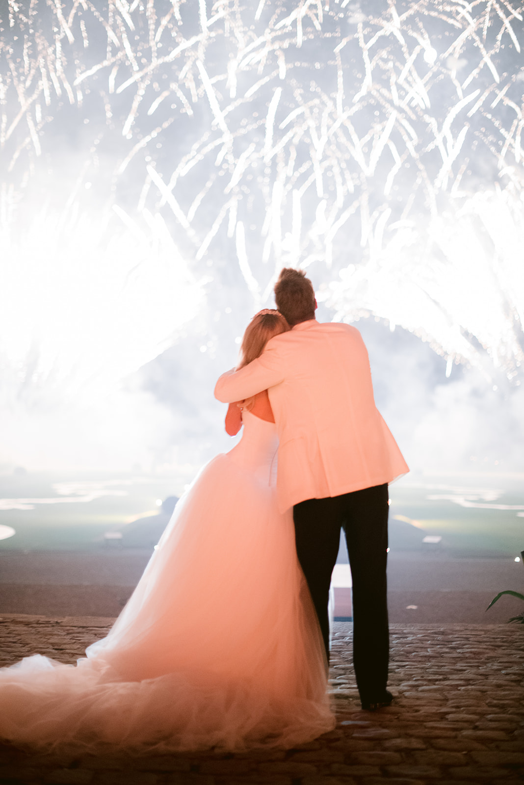 The bride and the groom looking at a firework for their wedding at chateau de vaux le vicomte 